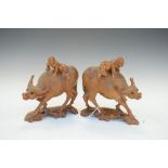 Pair of carved wooden Chinese buffalo, each carrying a child, 16cm high