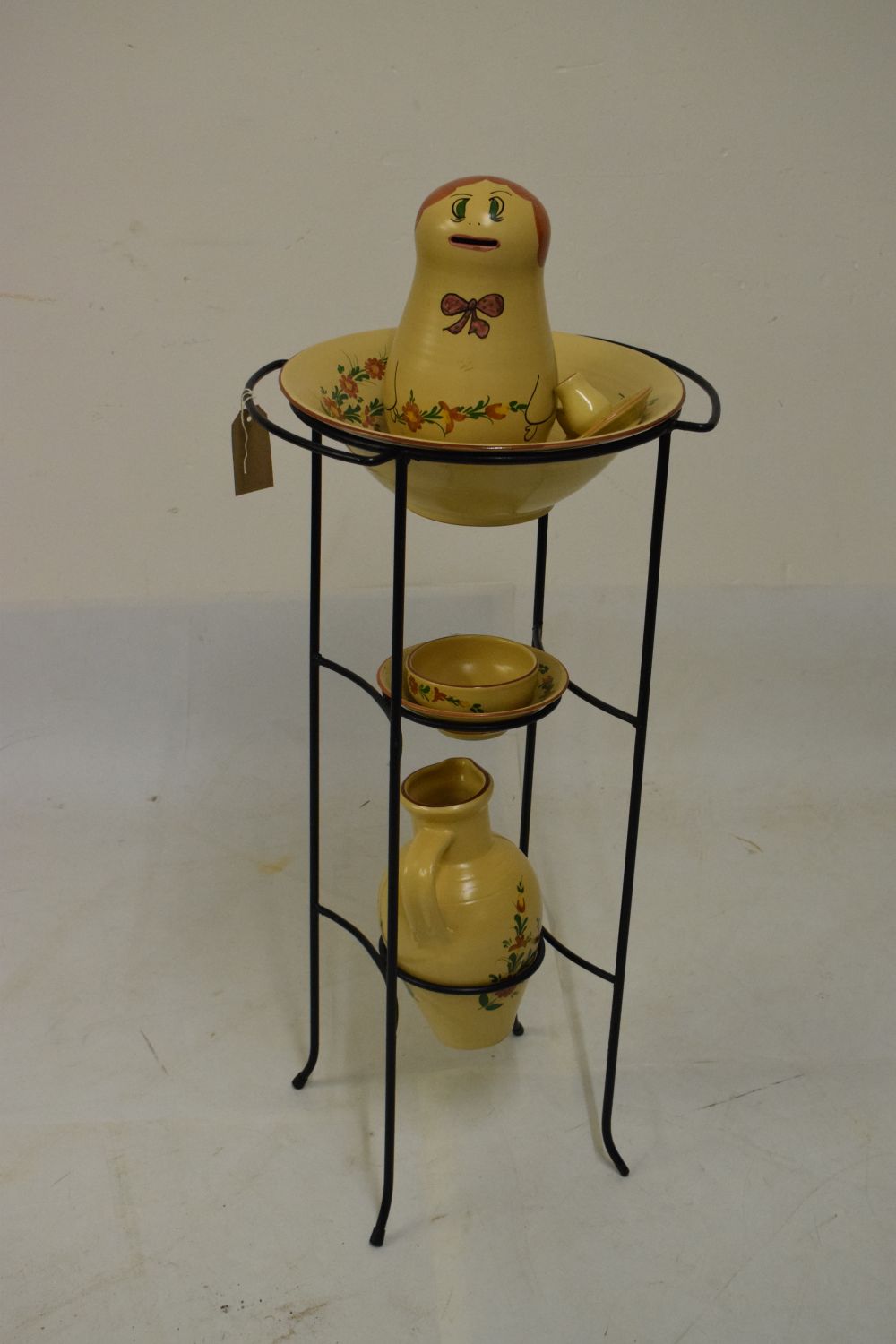 Cypriot pottery jug and basin set, on a metal stand, together with a similarly decorated moneybox