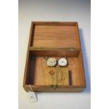 Wooden box containing two base metal open-face pocket watches and a small selection of costume