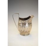 George III silver milk or cream jug of bulbous form with bright-cut engraved decoration, date