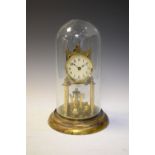 Mid 20th Century brass anniversary or torsion timepiece with four-ball pendulum beneath glass dome