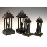 Two pairs of late 19th Century French black slate clock garniture porticoes, the larger with cast