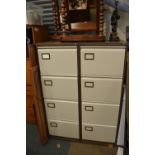 Two four-drawer metal filing cabinets