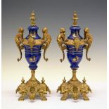 Pair of Continental gilt metal and ceramic urns, 35.5cm high