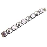 800-standard white metal panel bracelet of alternate foliate and amethyst-coloured oval cabochon