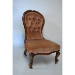 Victorian lady's walnut occasional or nursing chair with deep-buttoned spoon back and serpentine