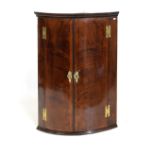 George III mahogany crossbanded bowfront corner cabinet