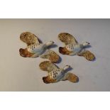 Three Beswick pink legged partridge wall plaques comprising, 1188-1, 1188-2 and 1188-3