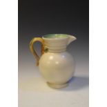 Large Clarice Cliff water jug having foliate handle, shape 895, 23cm high, moulded marks to base