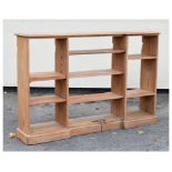 Stripped pine open bookcase of inverted breakfront design, 183cm x 35cm x 120cm high, together