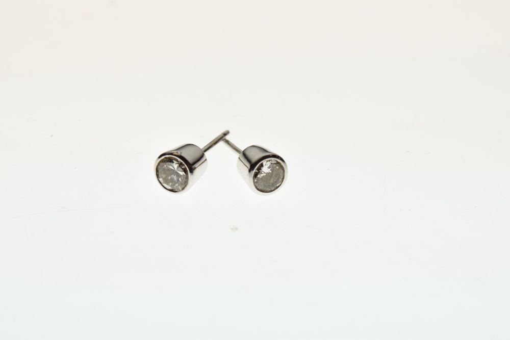 Pair of single stone diamond ear studs, the brilliant cut stones totalling approximately 0.7 - Image 2 of 4