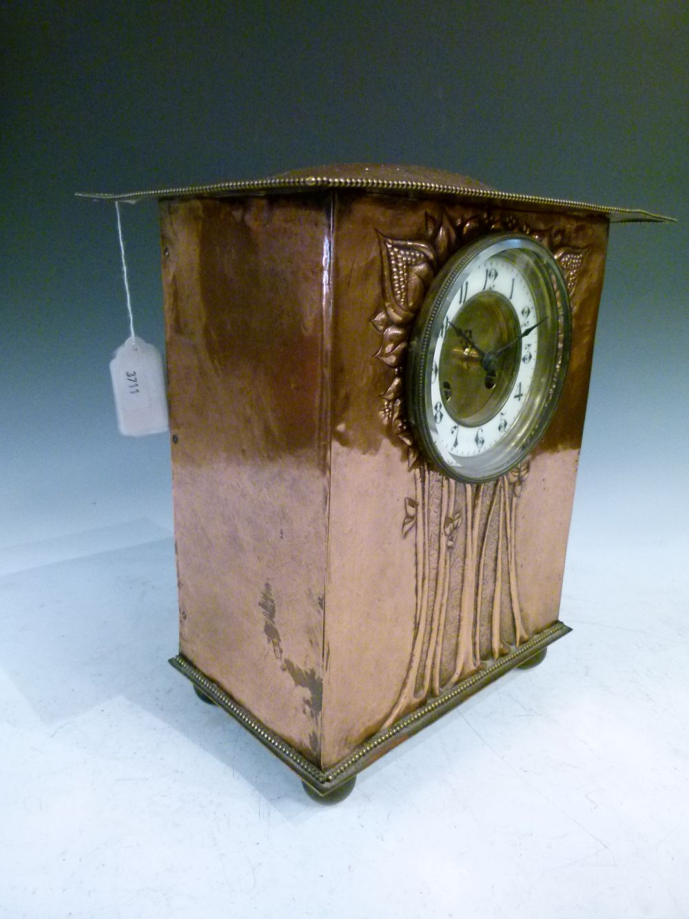 Arts & Crafts/Art Nouveau copper mantel clock, with humped overhanging roof above repousse flowering - Image 8 of 10