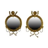 Pair of early 20th Century girandole mirrors, each of circular form with plain mirror plate