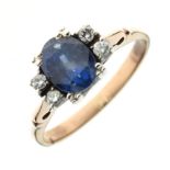 Sapphire and diamond ring, unmarked, the oval cut sapphire with pairs of brilliant cuts to either