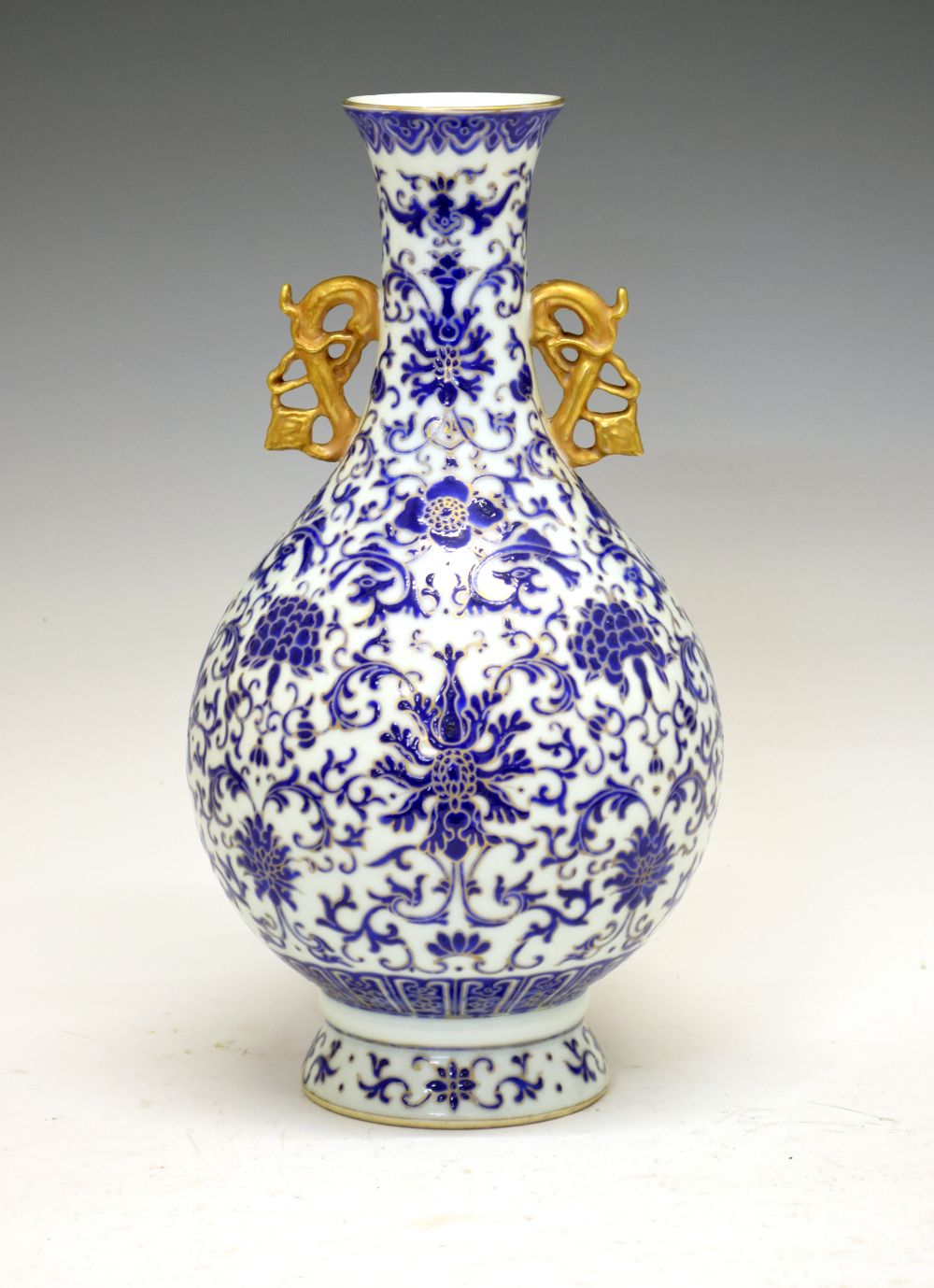 Chinese porcelain vase, of bulbous form with gilt handles and Royal blue enamel Ming-style floral