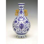 Chinese porcelain vase, of bulbous form with gilt handles and Royal blue enamel Ming-style floral