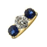 Diamond and sapphire three stone ring, the yellow mount stamped '18', the old brilliant cut of