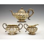 Early 19th Century matched three-piece silver tea set, of melon form with gilt interior, each