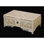 Early 20th Century Oriental ivory box or casket, with pierced rectangular cover and sides on four
