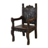 Renaissance Revival carved elm throne chair, the back headed by 'Green Man' mask between scrolls,