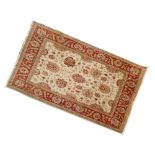 Ziegler-design wool rug, the beige field with typical flowerhead decoration, conforming abrashed