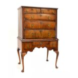 George II walnut chest on stand, the upper stage of two short and three graduated long drawers, each
