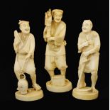 Three early 20th Century Japanese ivory okimono, late Meiji, modelled as a puppeteer, water-