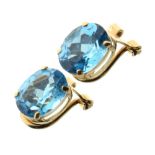 Pair of blue topaz ear clips, the oval cut stones to a yellow mount stamped '14k Mexico', 2.5g gross