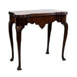 Early George III mahogany fold-over card table, of 'dog-ear' design, the hinged top enclosing corner