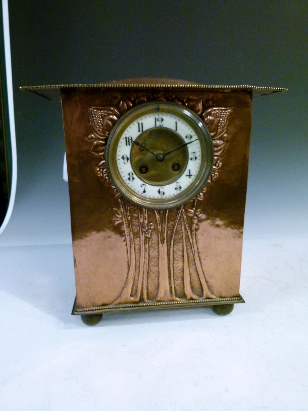 Arts & Crafts/Art Nouveau copper mantel clock, with humped overhanging roof above repousse flowering - Image 2 of 10