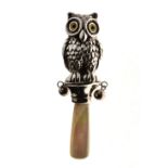 20th Century child's white metal rattle, in the form of an owl having two suspended bells and