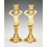 Pair of late Victorian Royal Worcester blush ivory figural candlesticks, each modelled as a semi-