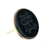 Intaglio monogram onyx signet ring, stamped '18ct', size J, 7.6g gross Condition: The circular panel