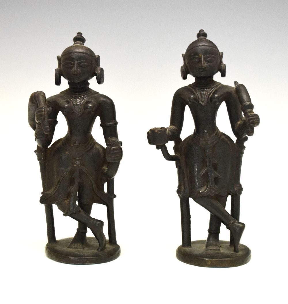 Pair of 18th or 19th Century Indian bronze figures, each modelled as an attendant with top-knot