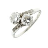 Two stone diamond crossover ring, stamped 'Fine Plat' and numbered '3301', the brilliant cuts of