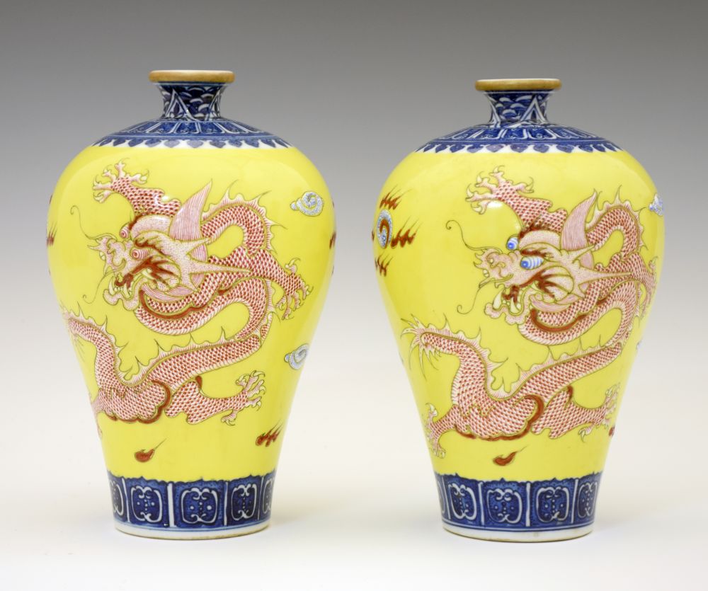 Pair of Chinese porcelain yellow ground Meiping vases, each finely decorated in shallow relief