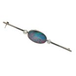Black opal and diamond bar brooch, the oval flat opal 19mm long x 11.5mm, flanked to either side