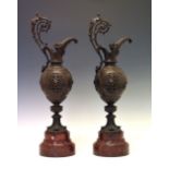 Pair of Renaissance Art revival patinated bronze ewers, each of pierced ovoid form with scroll