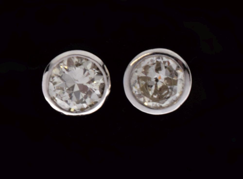 Pair of single stone diamond ear studs, the brilliant cut stones totalling approximately 0.7