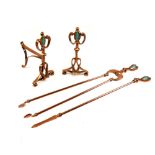 Unusual Art Nouveau copper fire companion set comprising: pair of fire dogs or andirons, tongs and