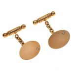 Pair of 9ct gold cufflinks, the plain oval panel set to one side with a small brilliant cut diamond,