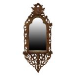 Continental carved pine or fruitwood console mirror, the plain triple-arched plate within foliate