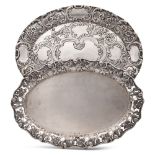 Two silver trays 19th - 20th century 30x23- 27,5x18 cm. oval shape, embossed and engraved, different