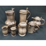 Antique pewter flagons and lidded vessels.
