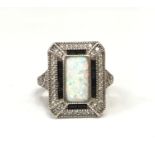 An Impressive silver CZ and central rectangular opal paneled ring, Size Q.