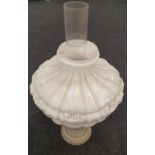 A vintage oil lamp with Vaseline glass shade. Includes chimney.