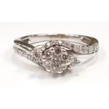 A 14ct white gold diamond cluster and diamond shoulder ring, Size L