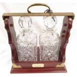 A modern tantalus with two cut crystal glass decanters. Includes key.