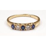 A Diamond and Sapphire 18ct gold half eternity ring, size M.