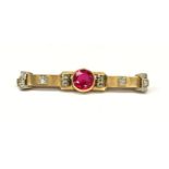 An 14ct yellow gold ruby and diamond bar brooch.